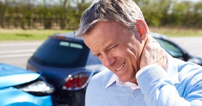 Man grasping neck and wincing after an auto accident