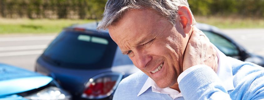 Man grasping neck and wincing after an auto accident