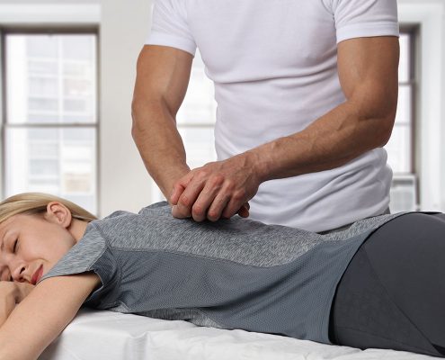 Woman receiving a chiropractic adjustment