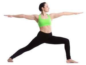 A woman in yoga clothes doing a lunge, arms outstretched