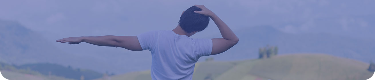 Banner image: a man standing in field, stretching his neck and shoulder
