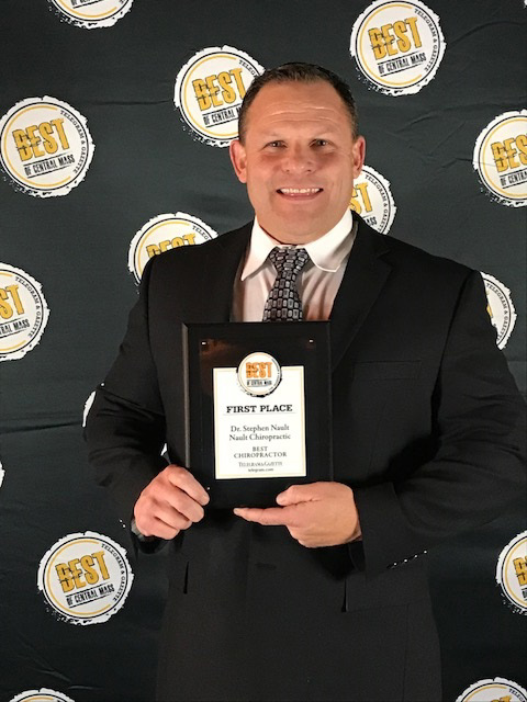 winner-2017 Doctor Nault holding his Best in Central Mass award for best chiropractor